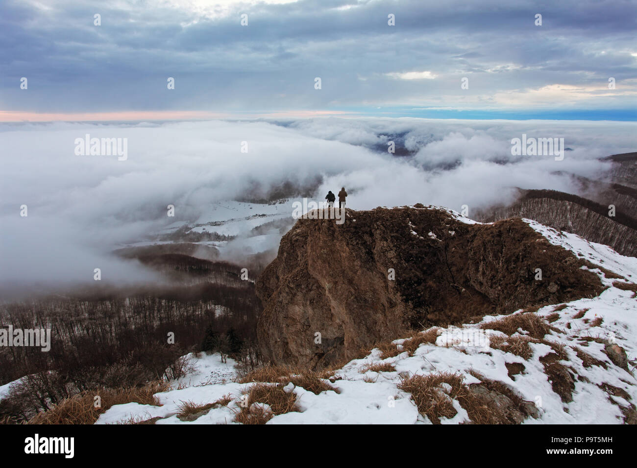 Cloudy mountain at winter with man Stock Photo