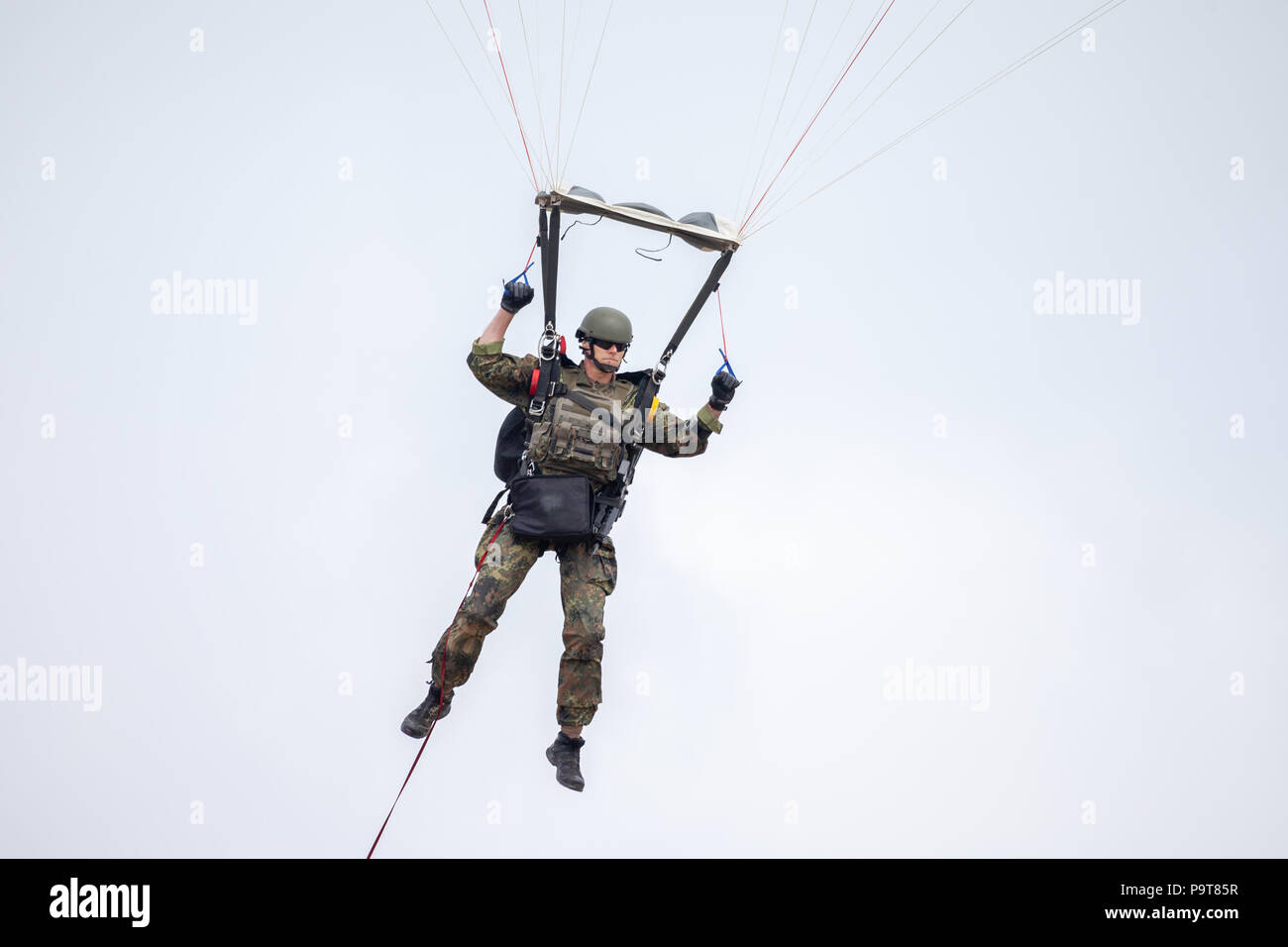 FELDKIRCHEN / GERMANY - JUNE 9, 2018: Paratrooper from Bundeswehr, german army lands on an open day on day of the Bundeswehr in Feldkirchen Stock Photo