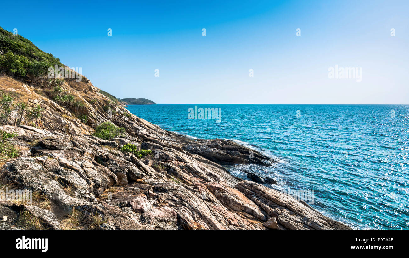 Stone shores coast  and Stone cliff be high and steep on Samet Island, Rayong, Thailand. Stock Photo