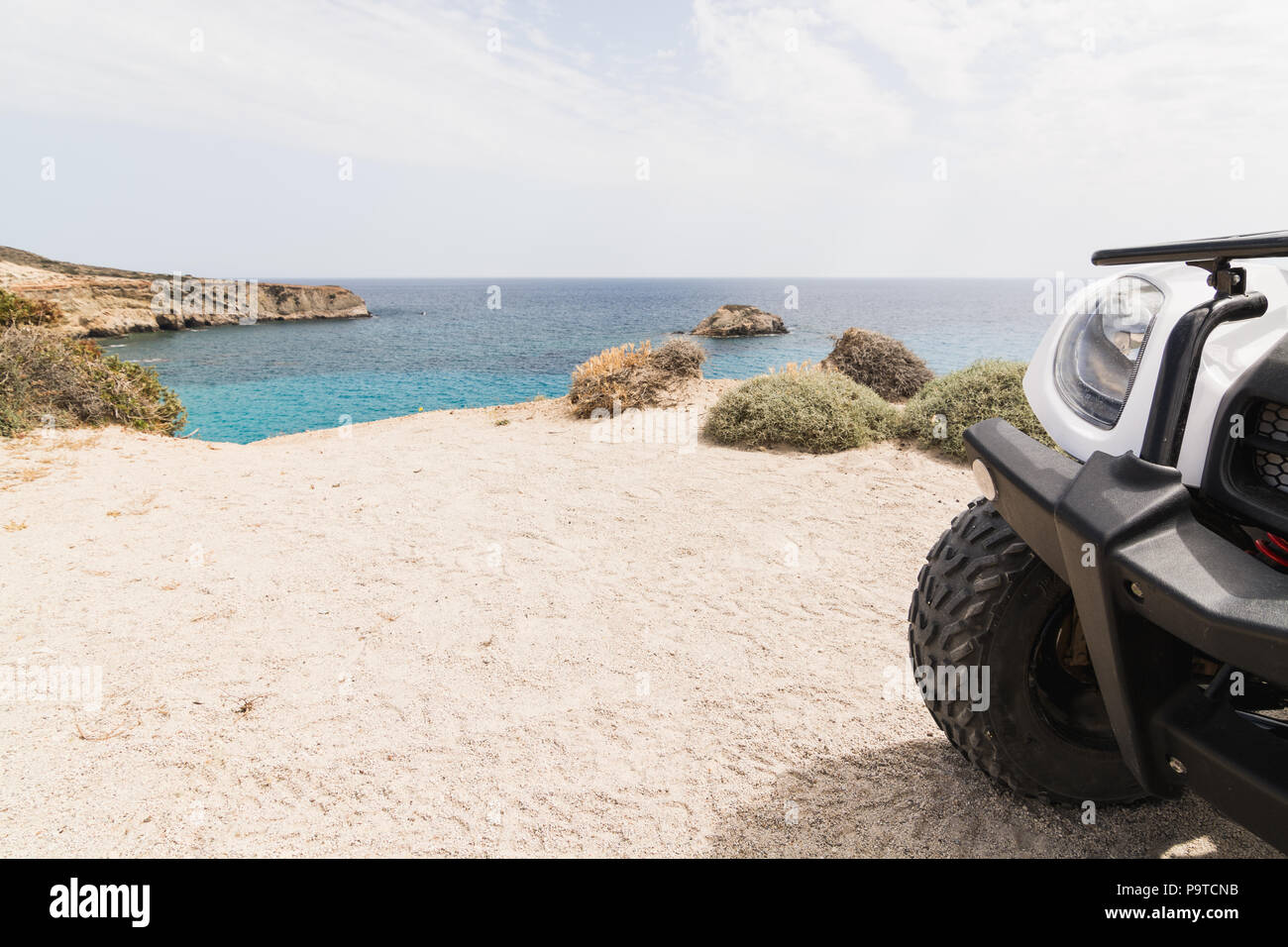 Quad atv bike standing on seaside road on Milos island, Greece Stock