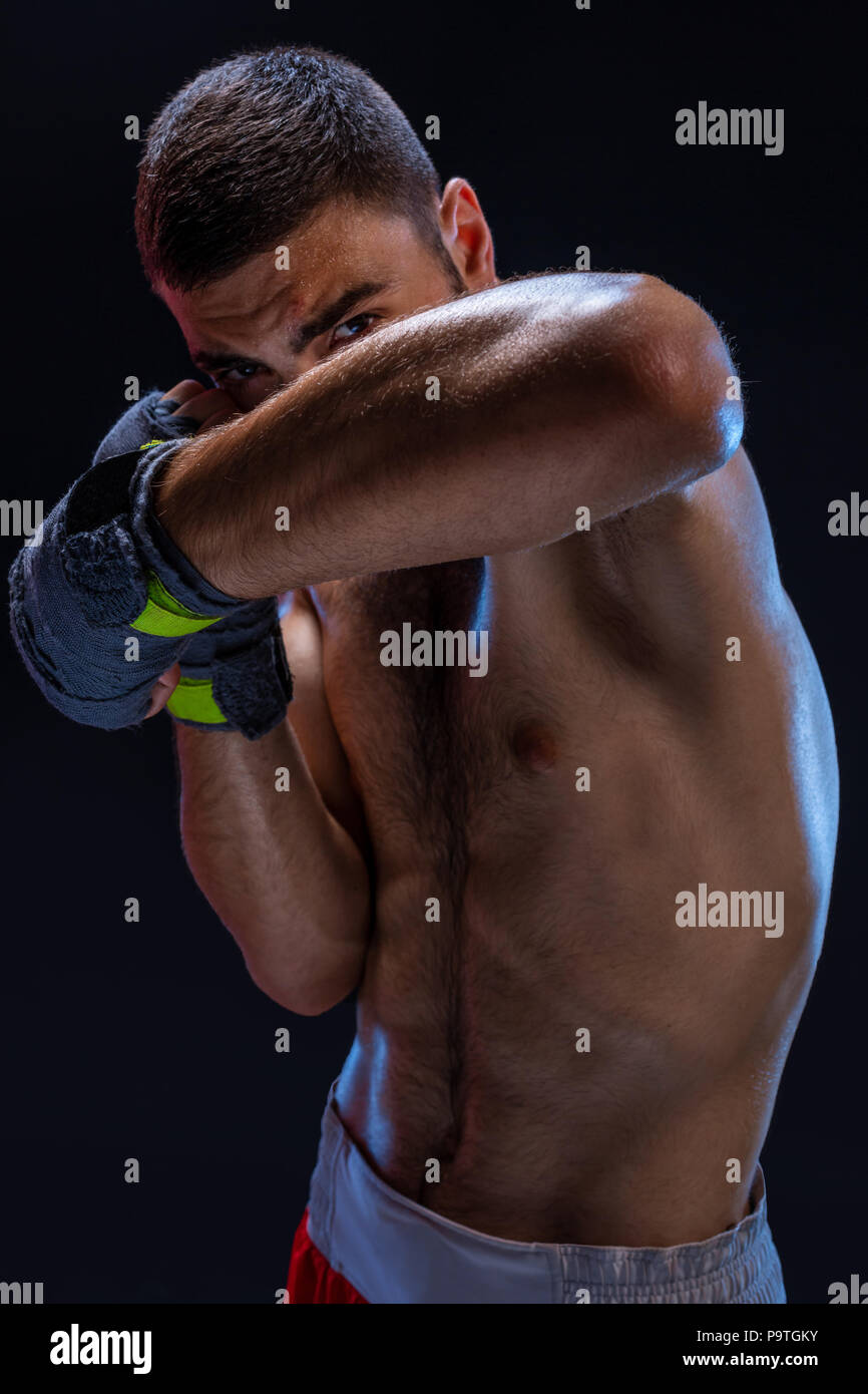 Double arm block. Boxing trainer showing defensive techniques. Combat sport, fight club. Studio