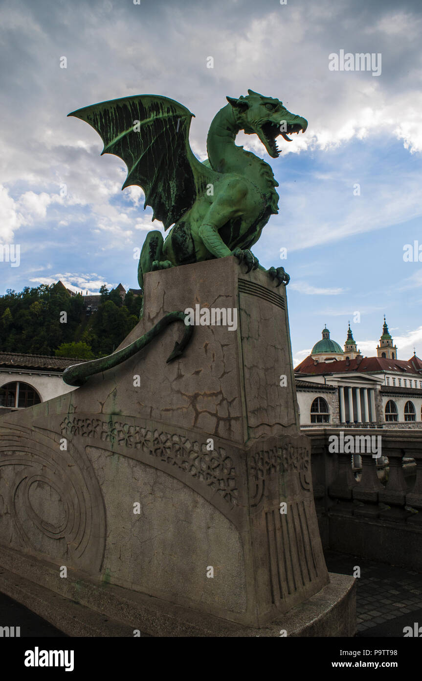 Dragon statue by Jurij Zaninović on the Dragon Bridge (Zmajski most), the most famous road bridge of Ljubljana built in the early 20th century Stock Photo