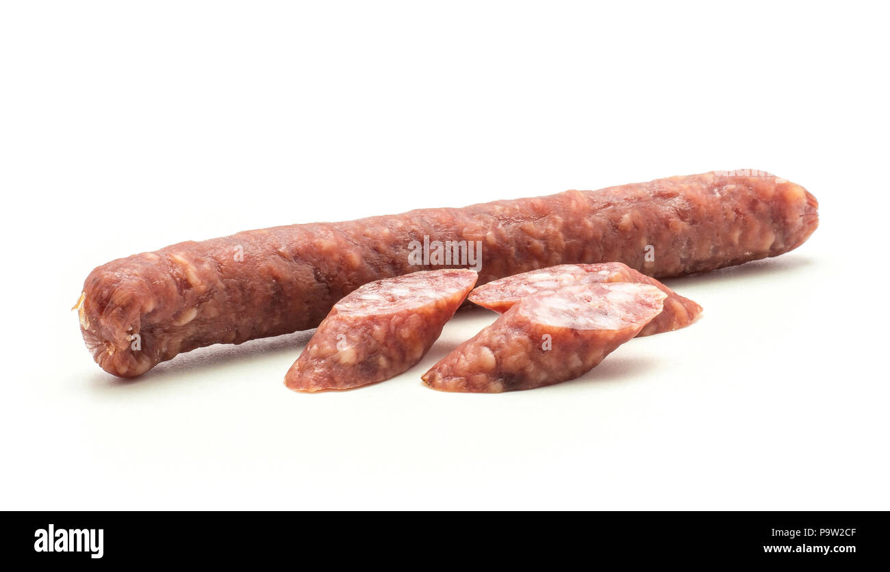 One Hungarian dry sausage pepperoni with three cut pieces isolated on white background smoked in
