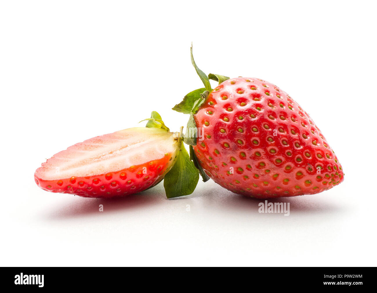 Ripe garden strawberry and one half isolated on white background Stock Photo