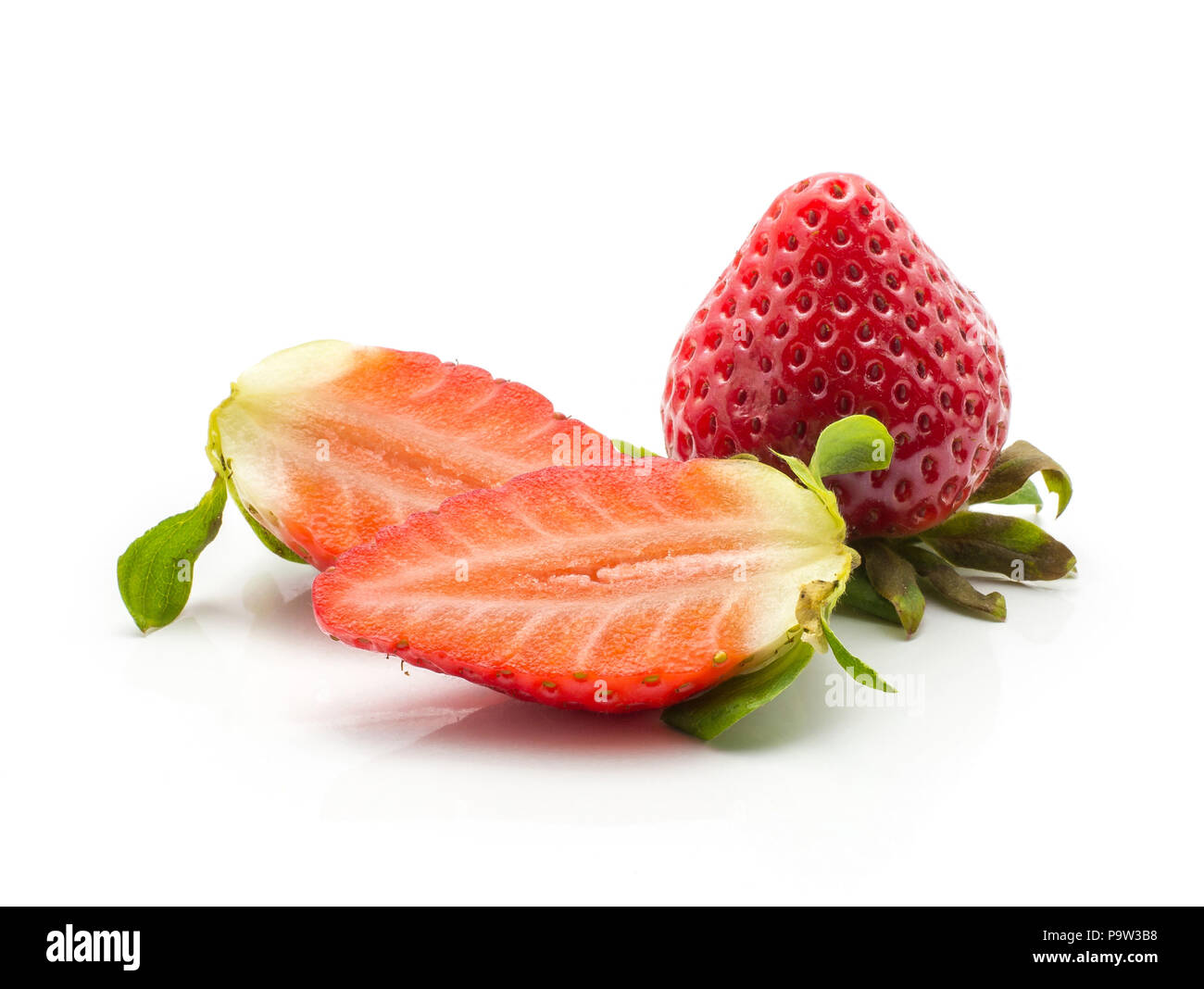 Two garden strawberries one sliced in two halves isolated on white background Stock Photo