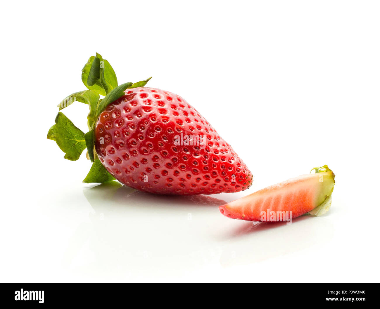Garden strawberry and one slice isolated on white background fresh cut Stock Photo