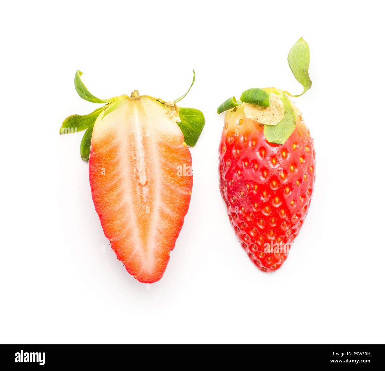 Garden strawberry top view one whole and one cross section half compare isolated on white background Stock Photo