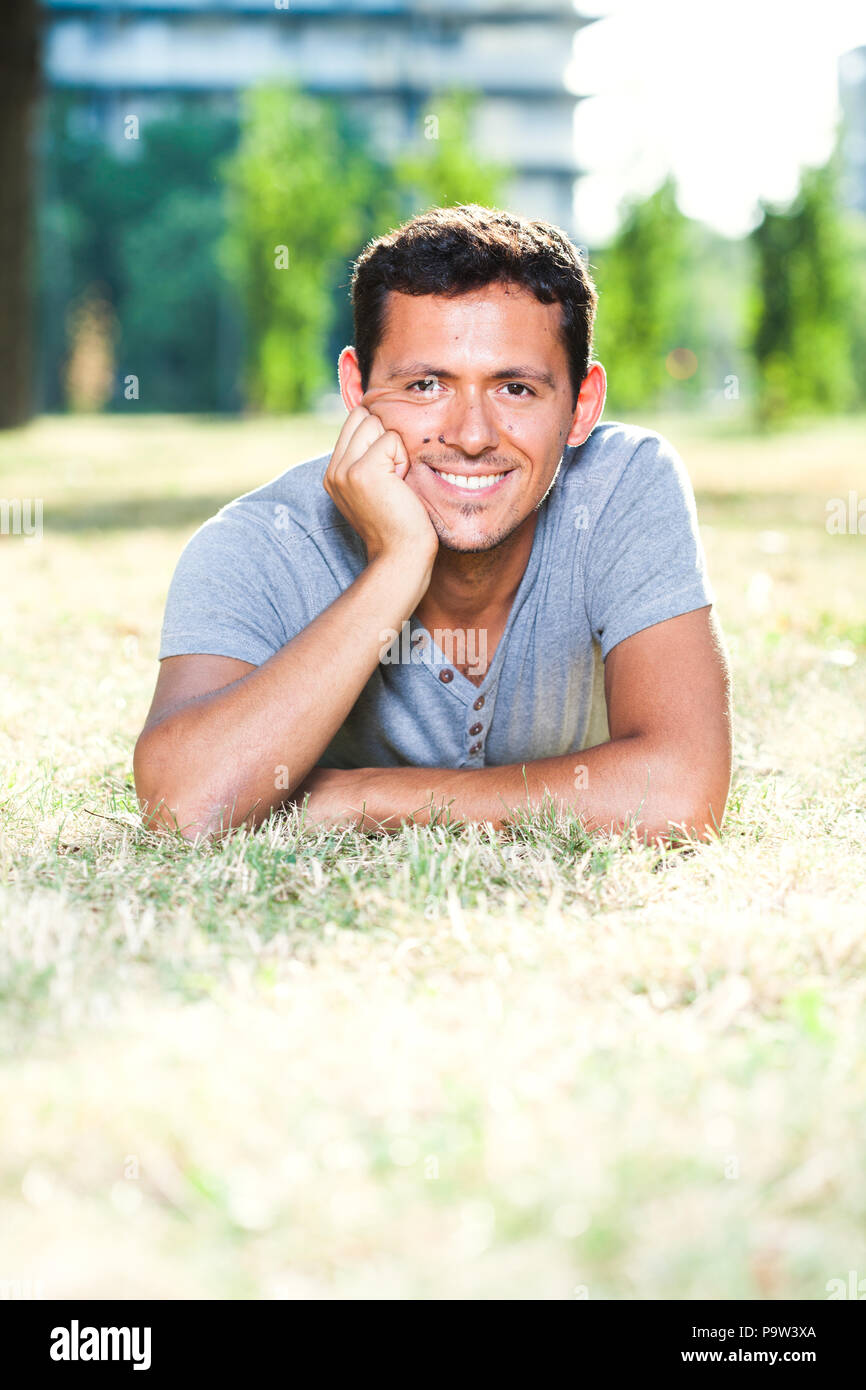 Young happy man smiling on a summer day in park Stock Photo