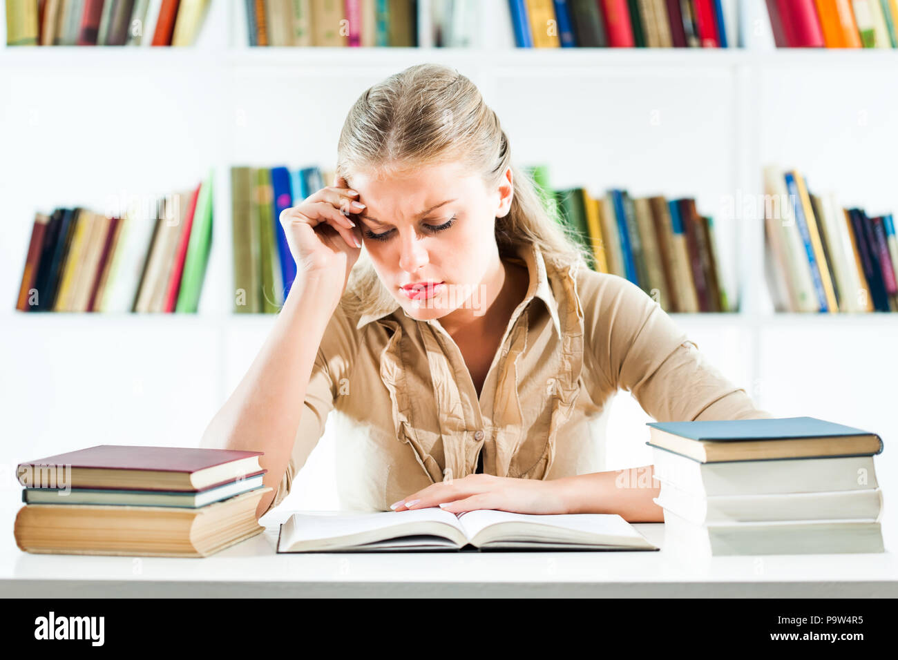 Student learning in library, she is tired Stock Photo - Alamy