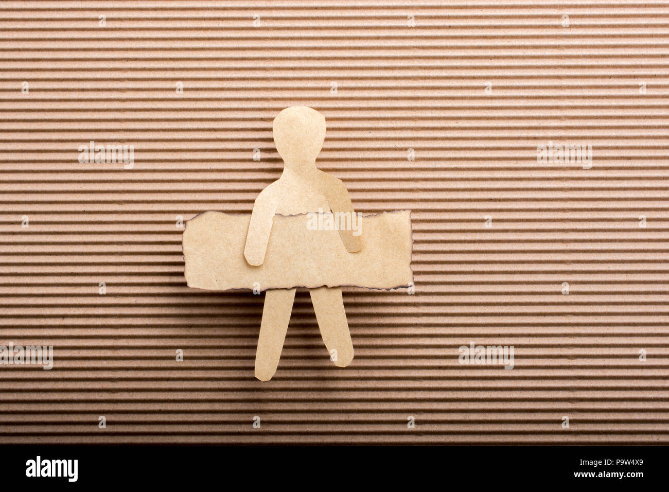 Paper man shape holding burnt note paper in hand Stock Photo