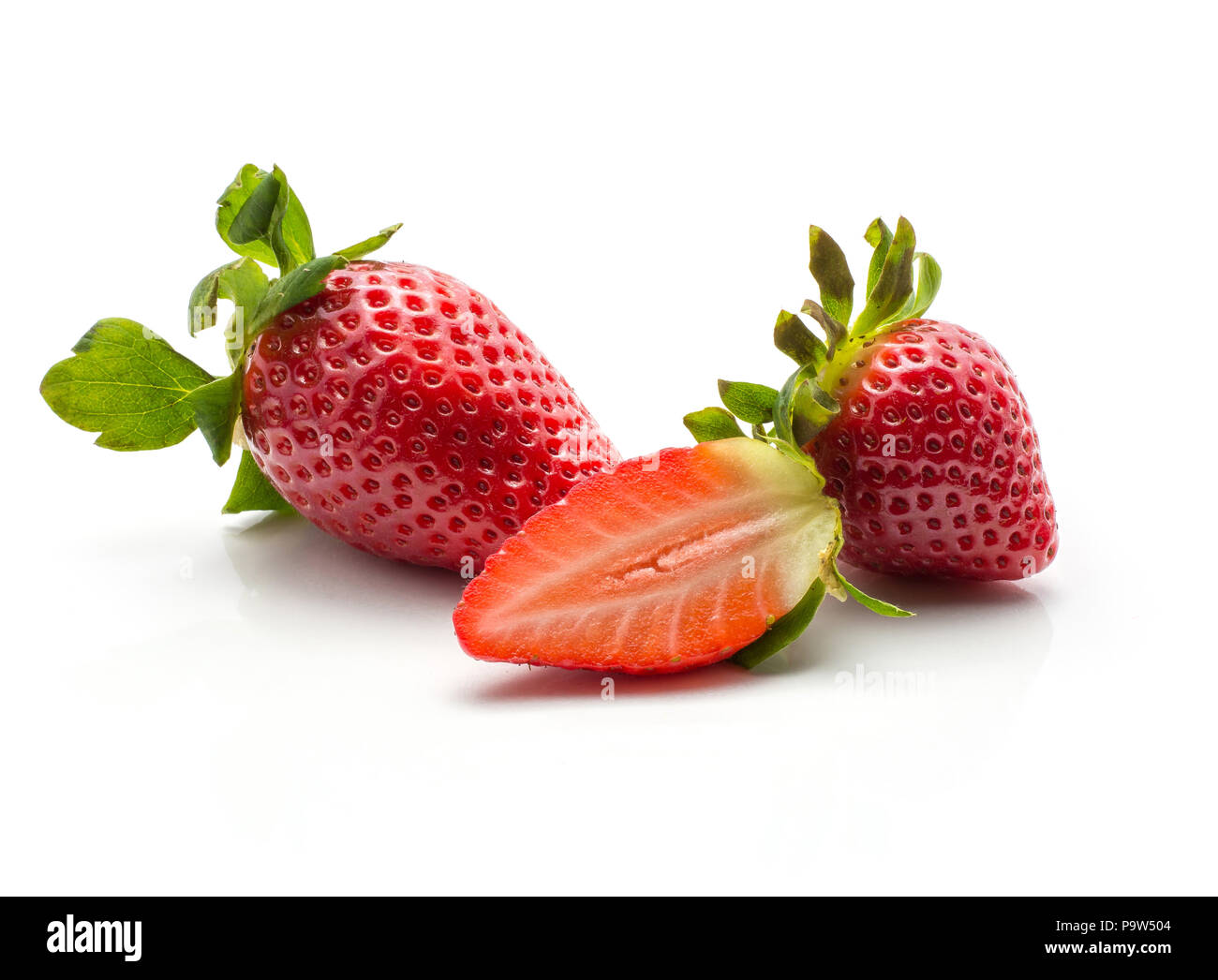 Two garden strawberries and one fresh cut half isolated on white background Stock Photo
