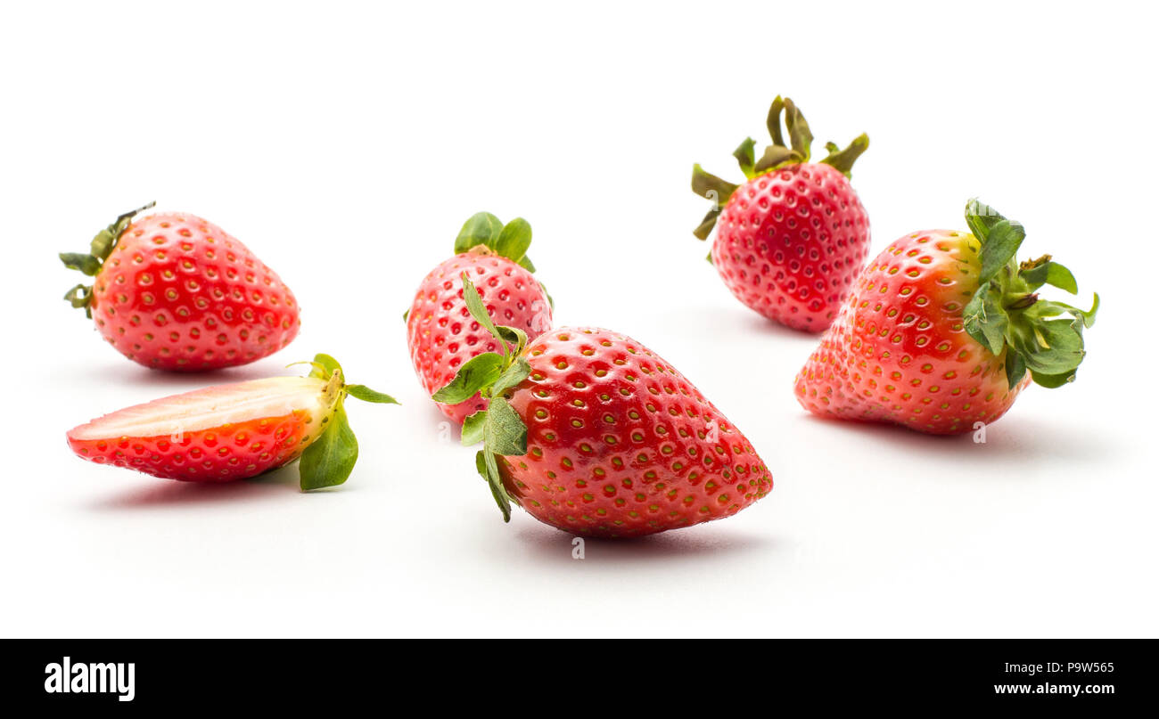 Ripe garden strawberries isolated on white background five whole and one half Stock Photo