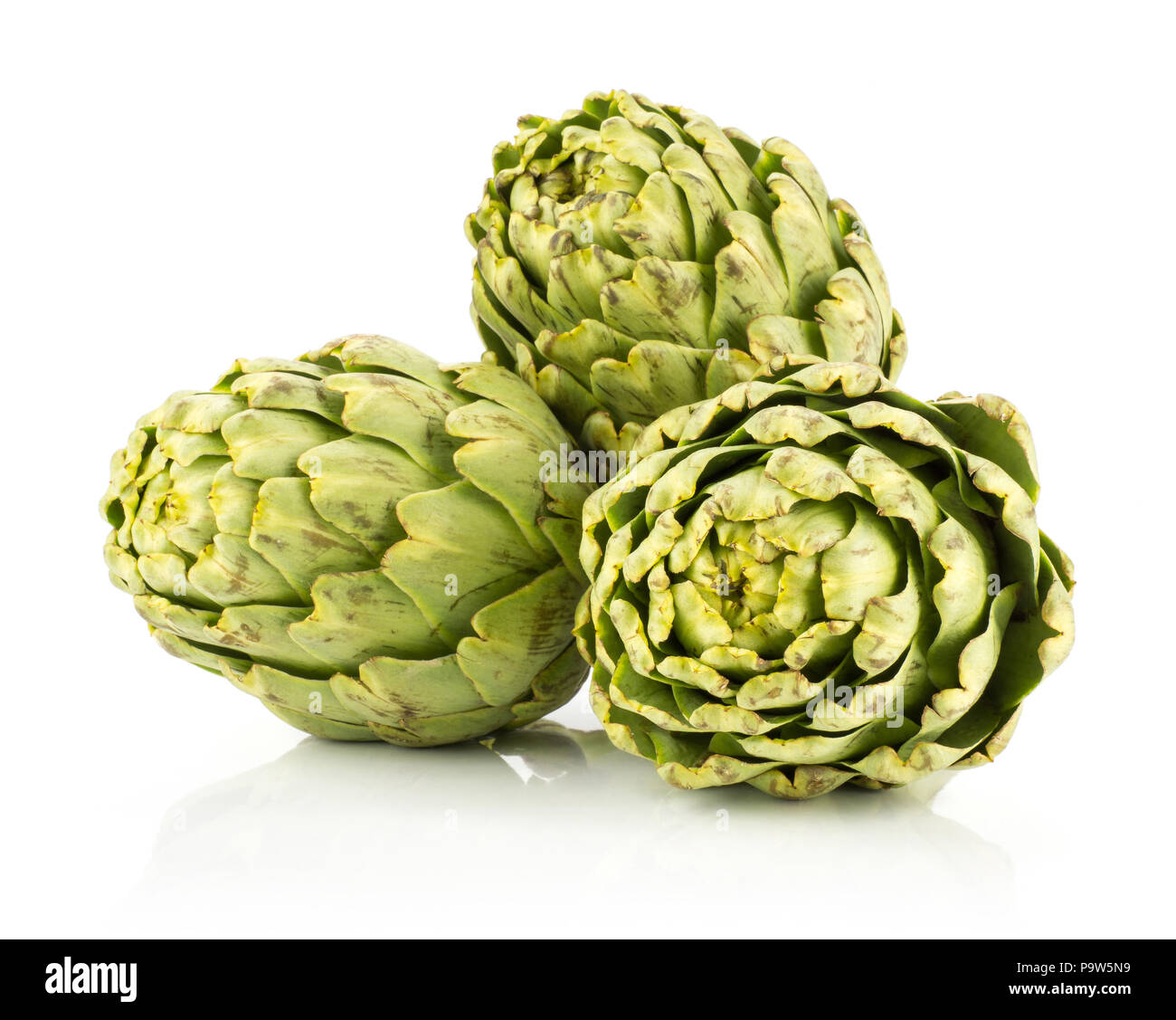 Three globe artichoke flowers isolated on white background raw fresh green stack Stock Photo Alamy