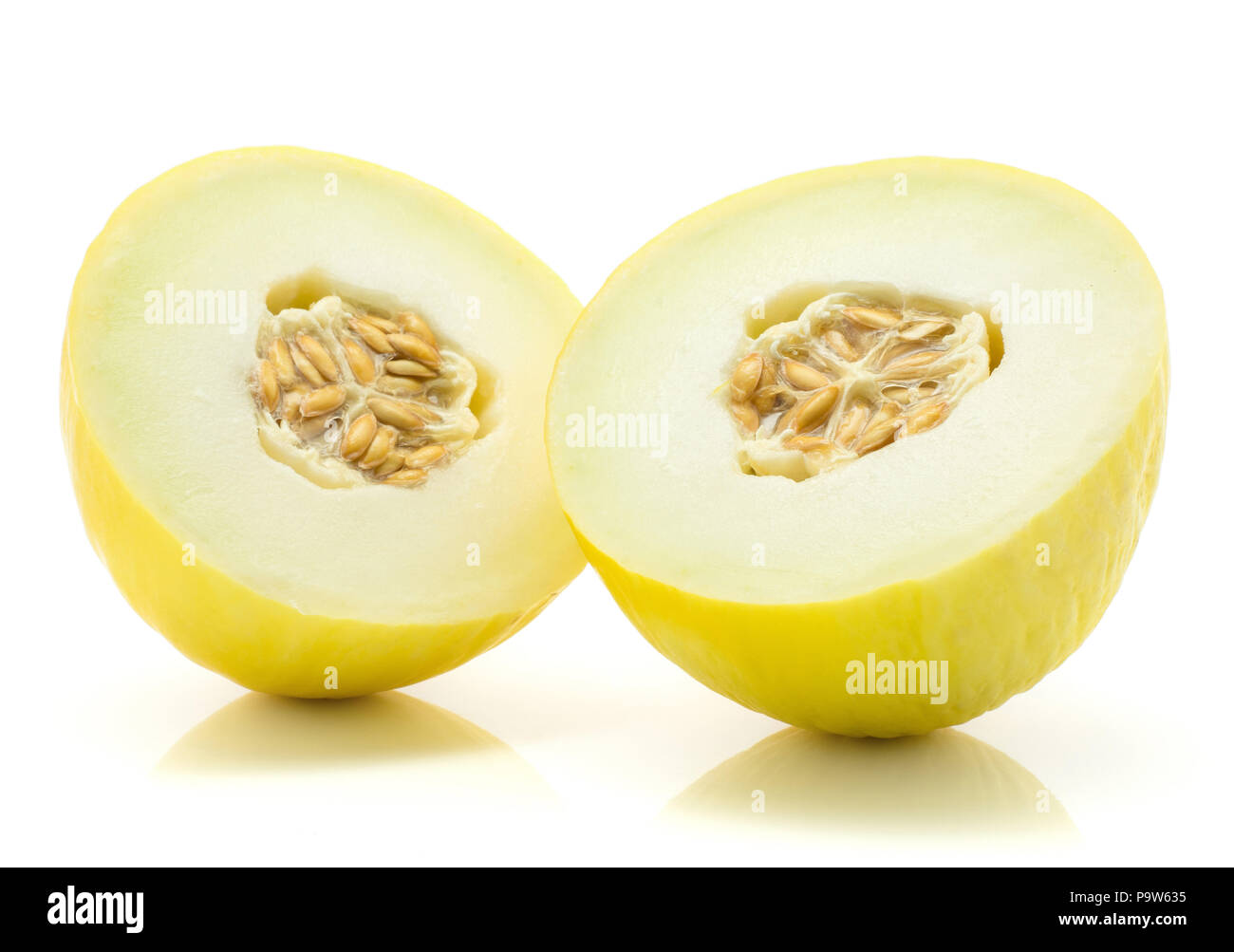 Yellow honeydew melon halves with seeds isolated on white background one cut in half Stock Photo