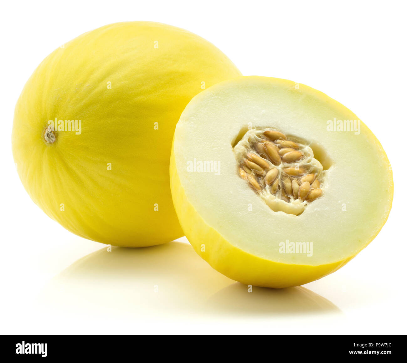 Yellow honeydew melon and one half with seeds isolated on white background Stock Photo