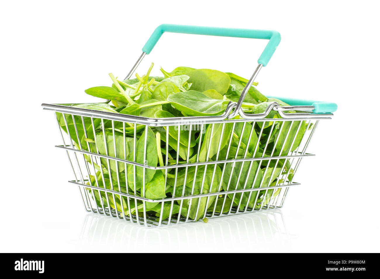Fresh baby spinach leaves in a shopping basket isolated on white background Stock Photo