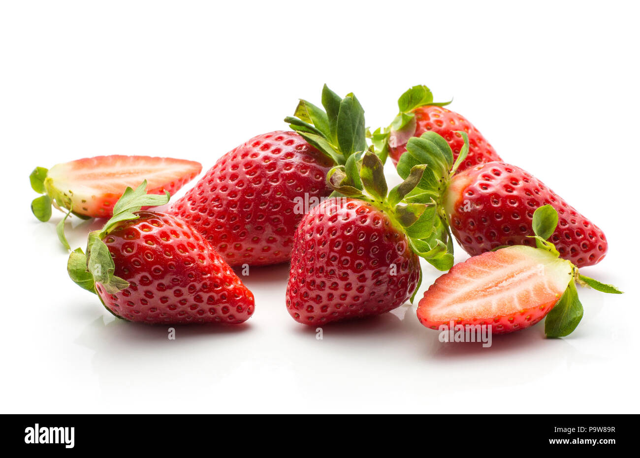 Garden strawberries set isolated on white background ripe whole and one cut in half Stock Photo