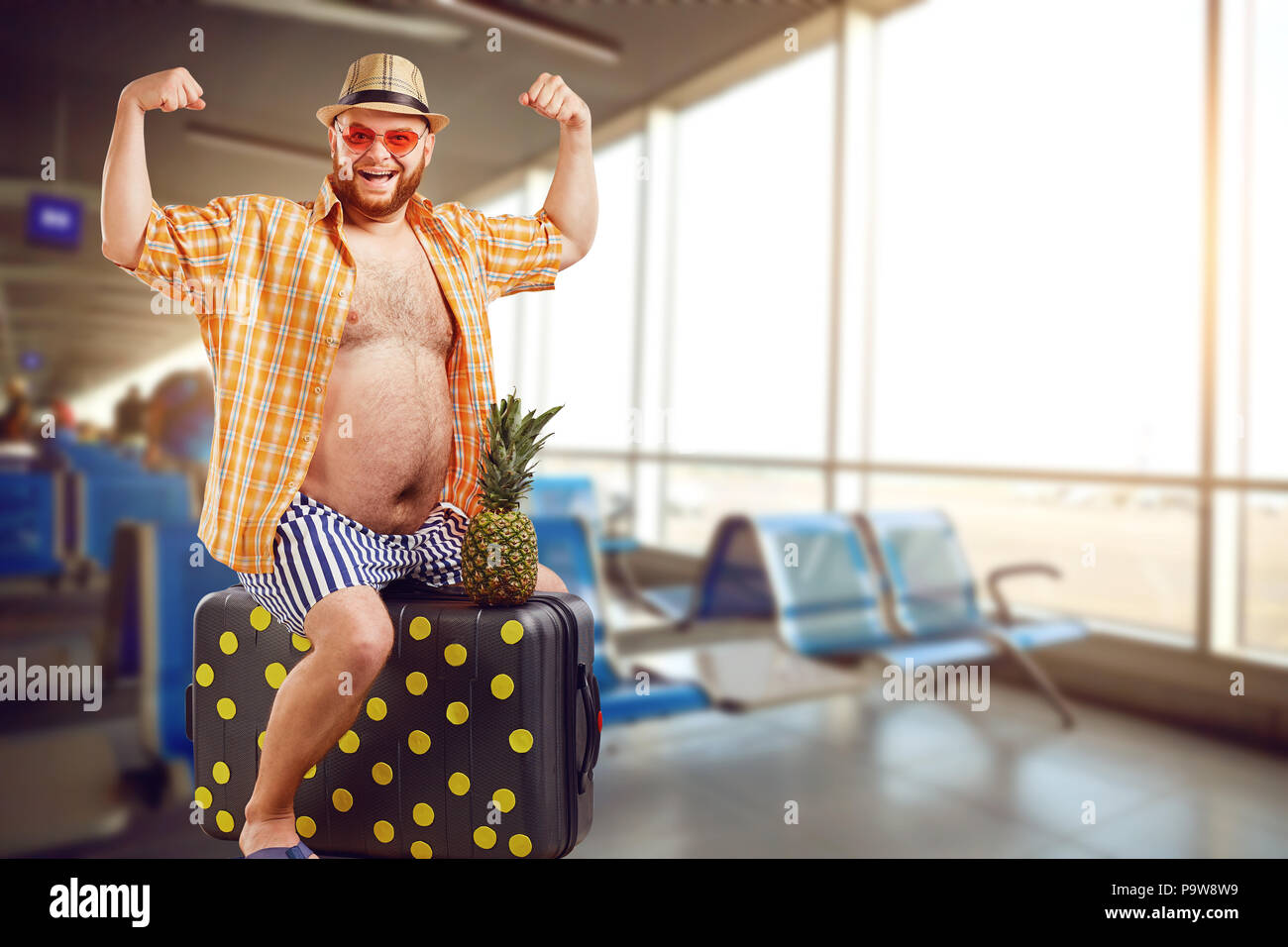 A funny fat tourist with a suitcase at the airport Stock Photo - Alamy