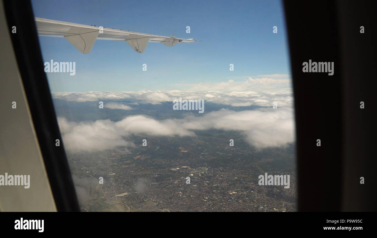 View through an airplane window on the city. Airplane window view