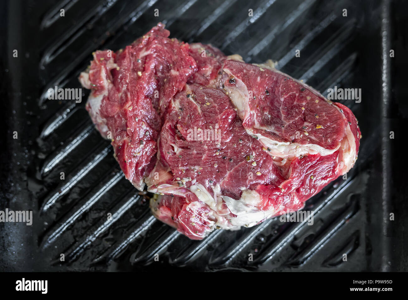 Close Up Raw Tasty Fresh Rib Eye Steak On Grill Cast Iron Pan Organic Beef Meat Seasoned With Ground Pepper Cooked On Barbecue Stock Photo Alamy