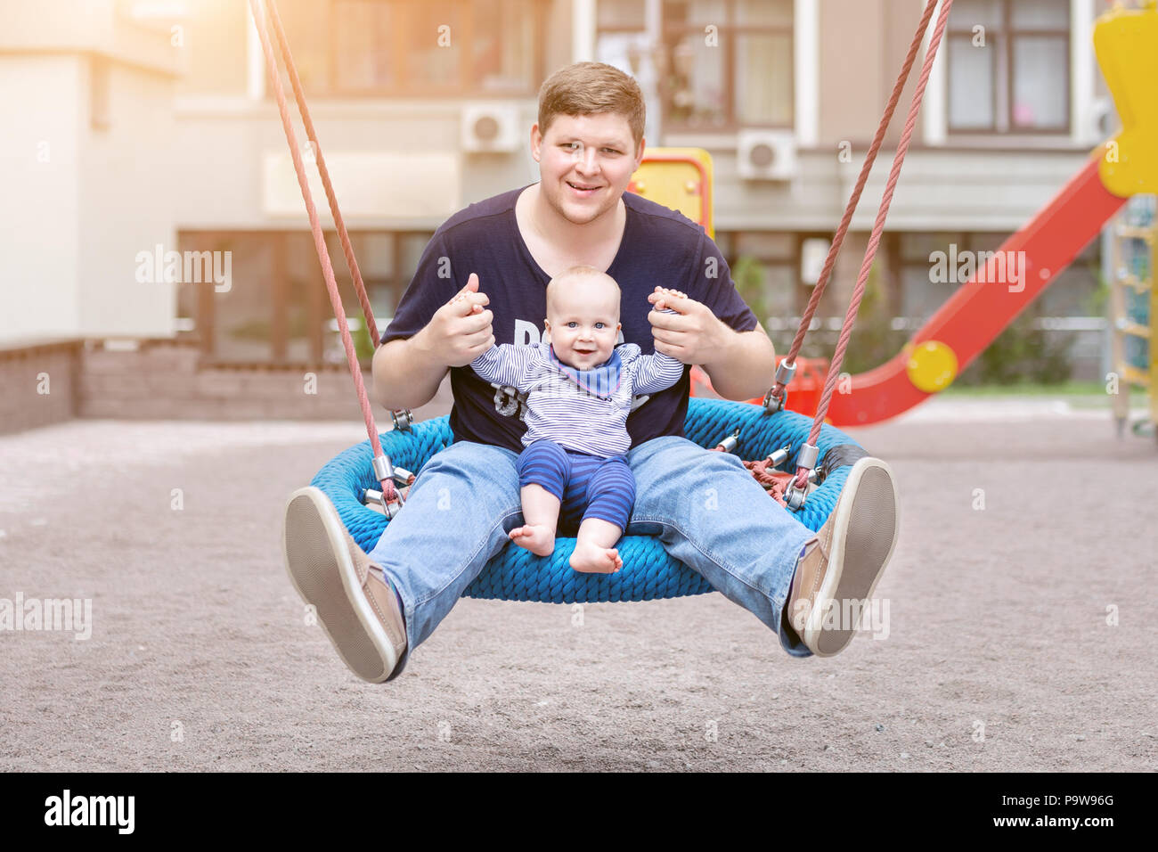 Father With Son Sitting On Big Modern Chain Swing And Laughing Parent With Baby Boy Enjoying Swinging On Seesaw At Playground Happy Childhood And Pa Stock Photo Alamy Father With Son Sitting On Big Modern Chain Swing And Laughing Parent With Baby Boy Enjoying Swinging On Seesaw At Playground Happy Childhood And Pa Stock Photo Alamy