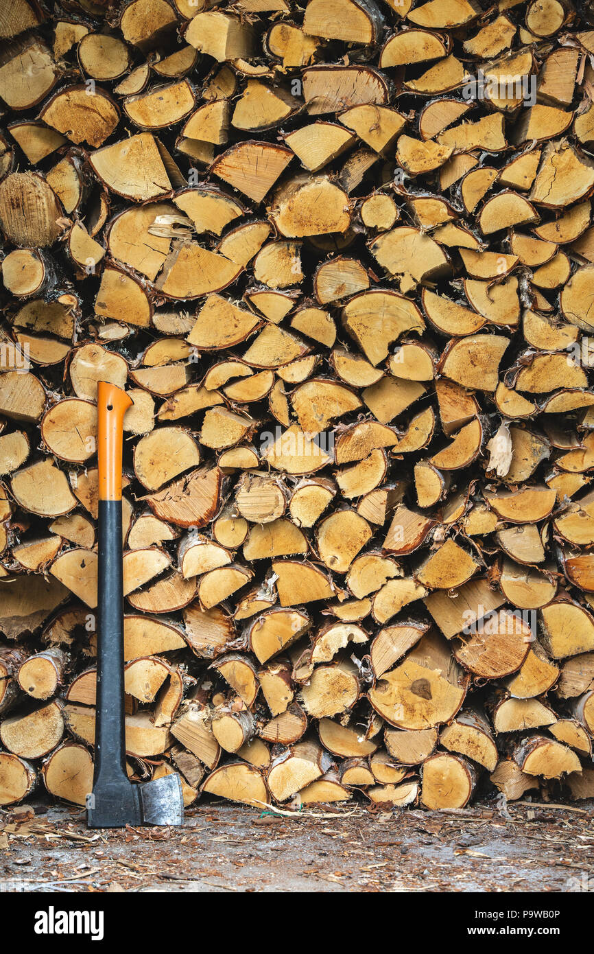 Pile of wood to burn and axe Stock Photo
