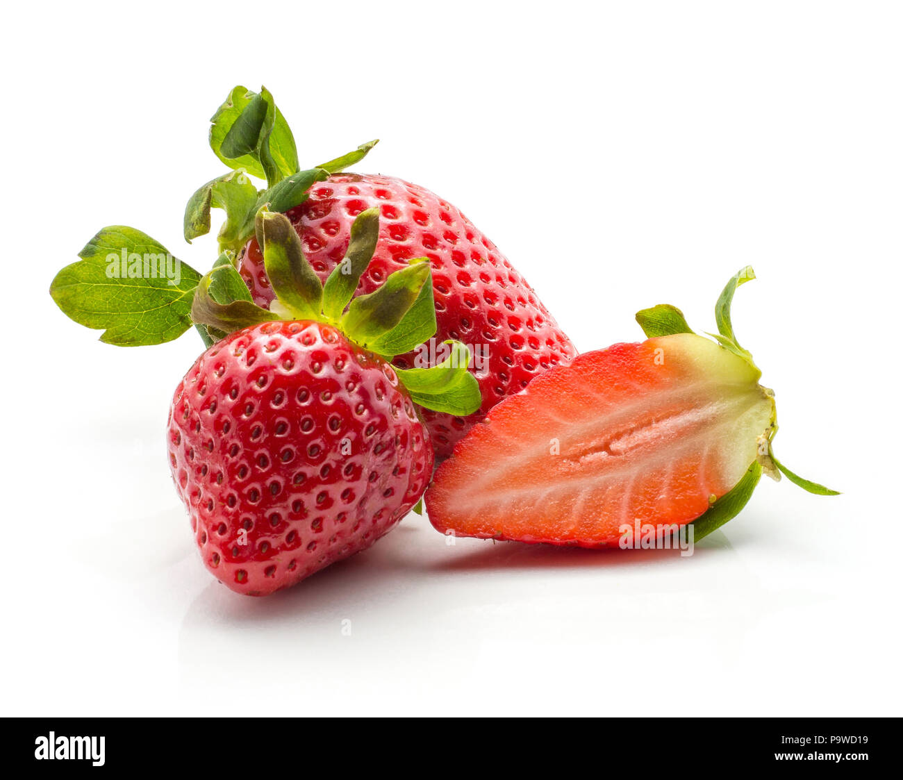 Two garden strawberries one fresh cut half isolated on white background Stock Photo