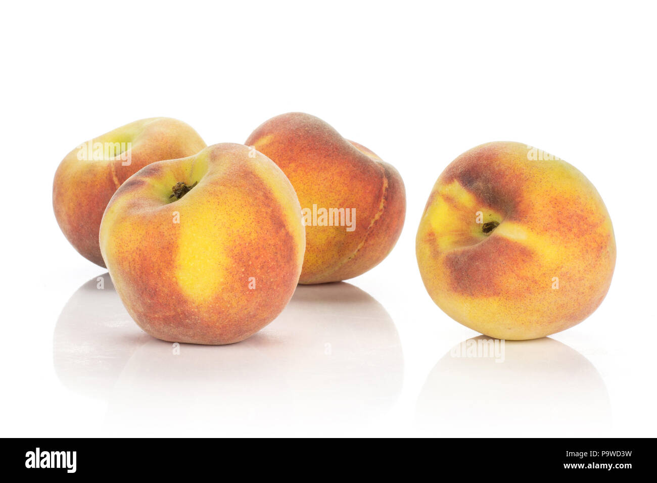 Four ripe yellow peaches isolated on white background Stock Photo - Alamy