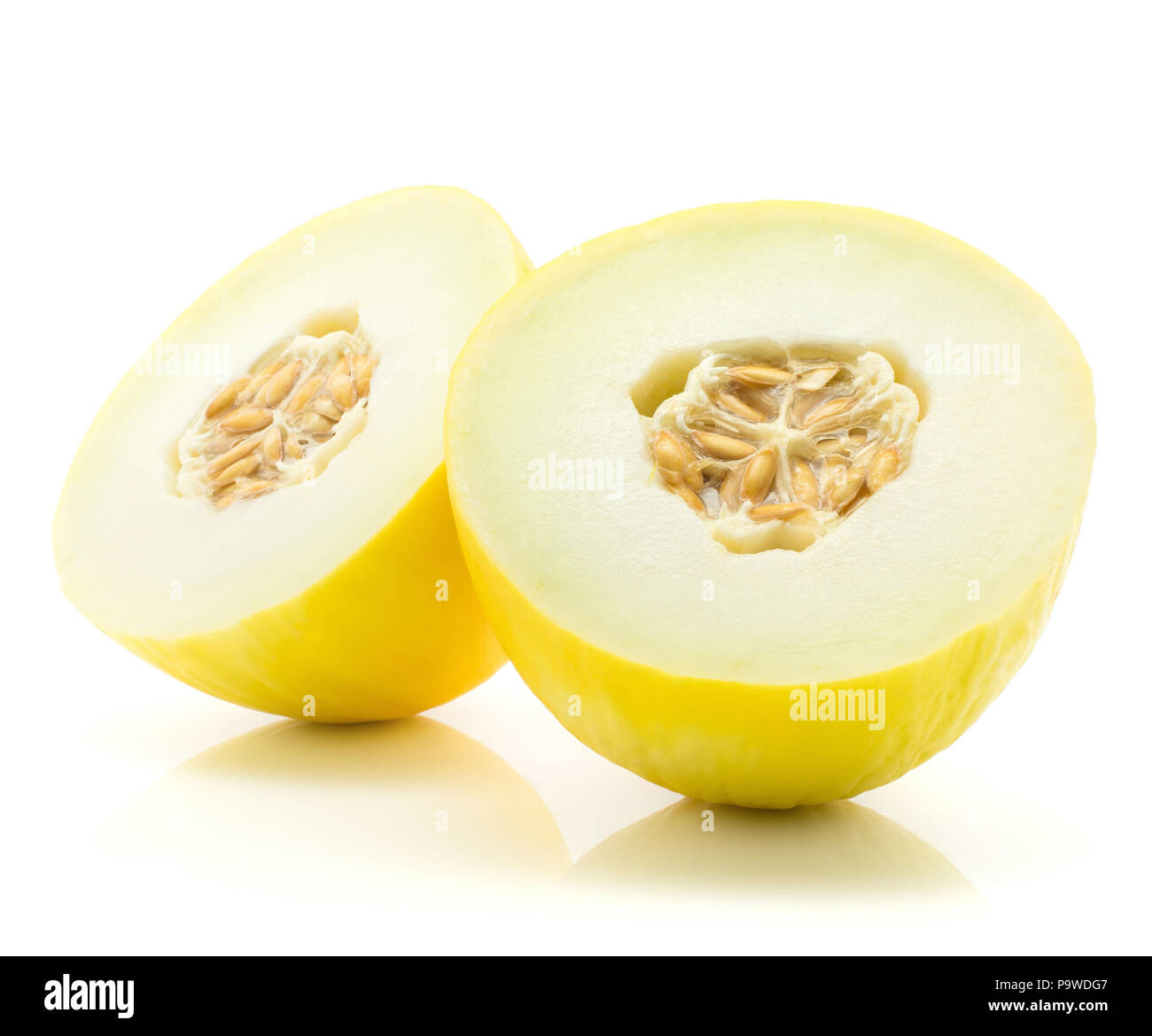 Yellow honeydew melon cut in half isolated on white background two halves with seeds Stock Photo