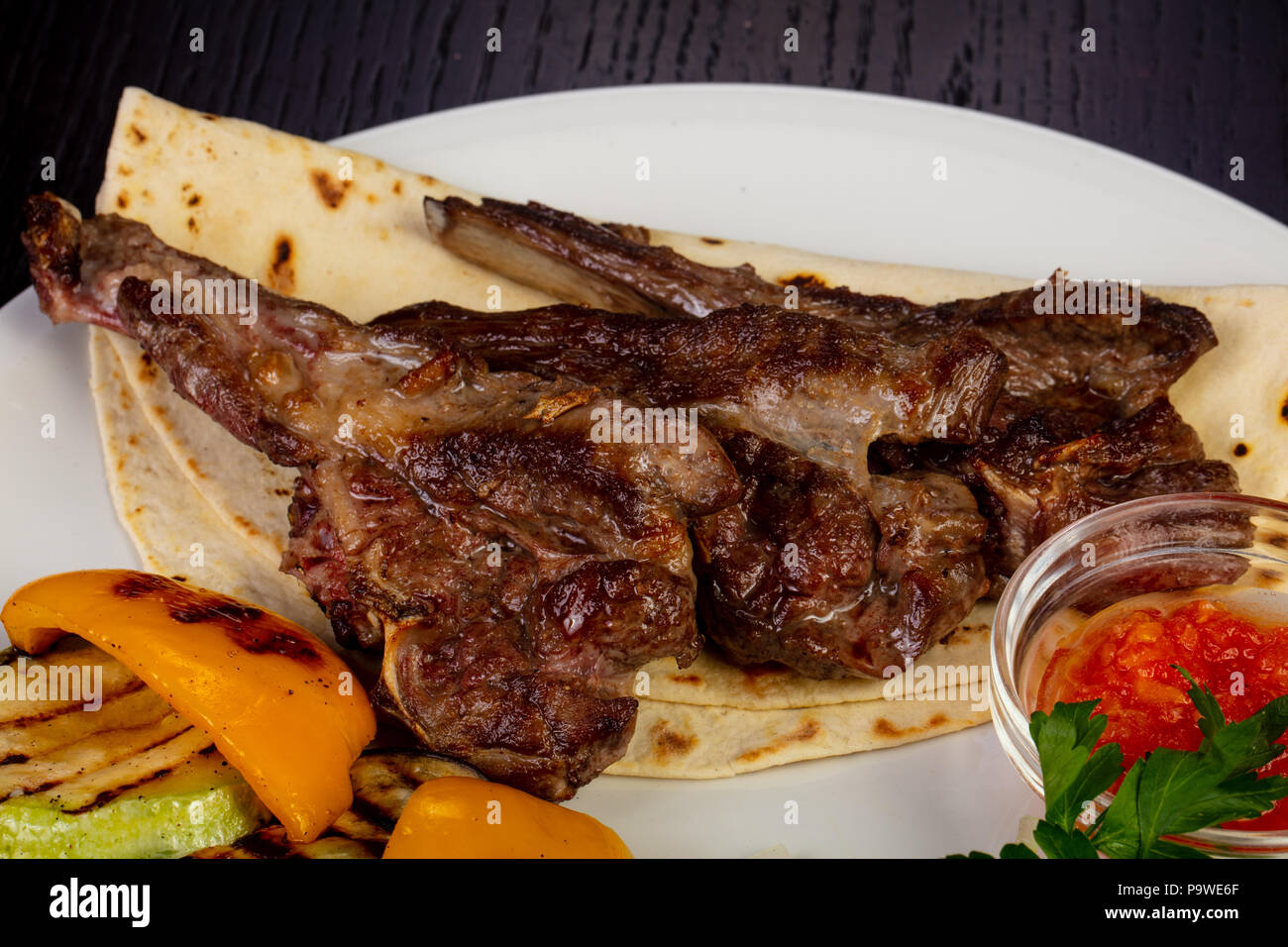 Delicious fried lamb loin with pita and roasted pepper Stock Photo - Alamy