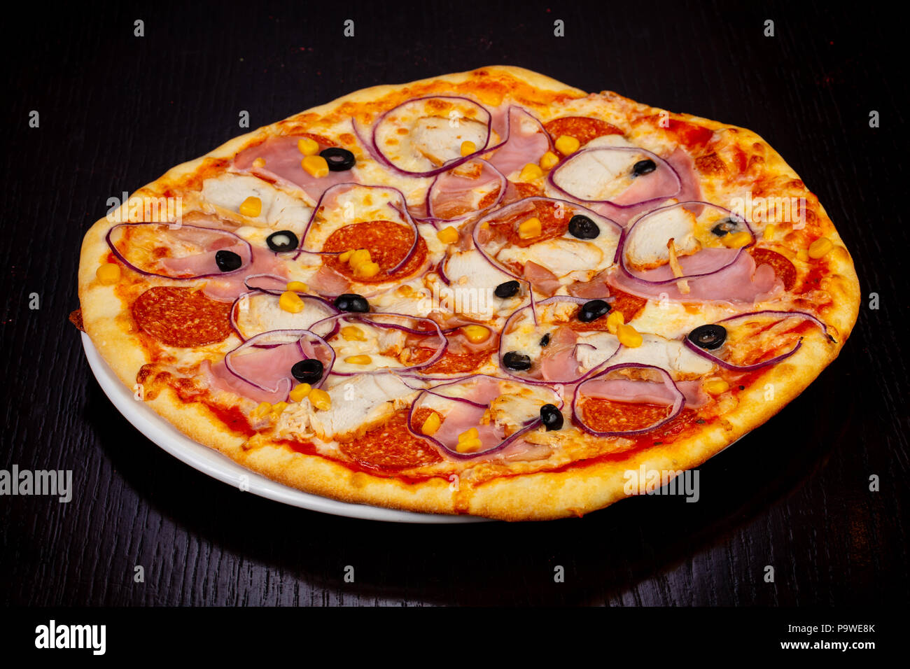 Delicious meat pie pizza with salami, ham and onions Stock Photo Alamy