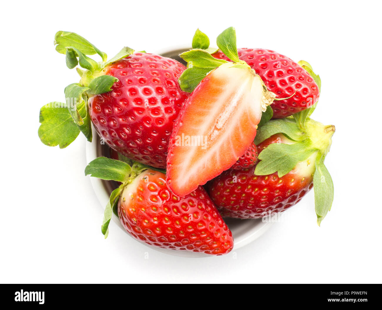 Garden strawberries in a ceramic top view isolated on white background ideal breakfast one fleshy sliced half on top Stock Photo