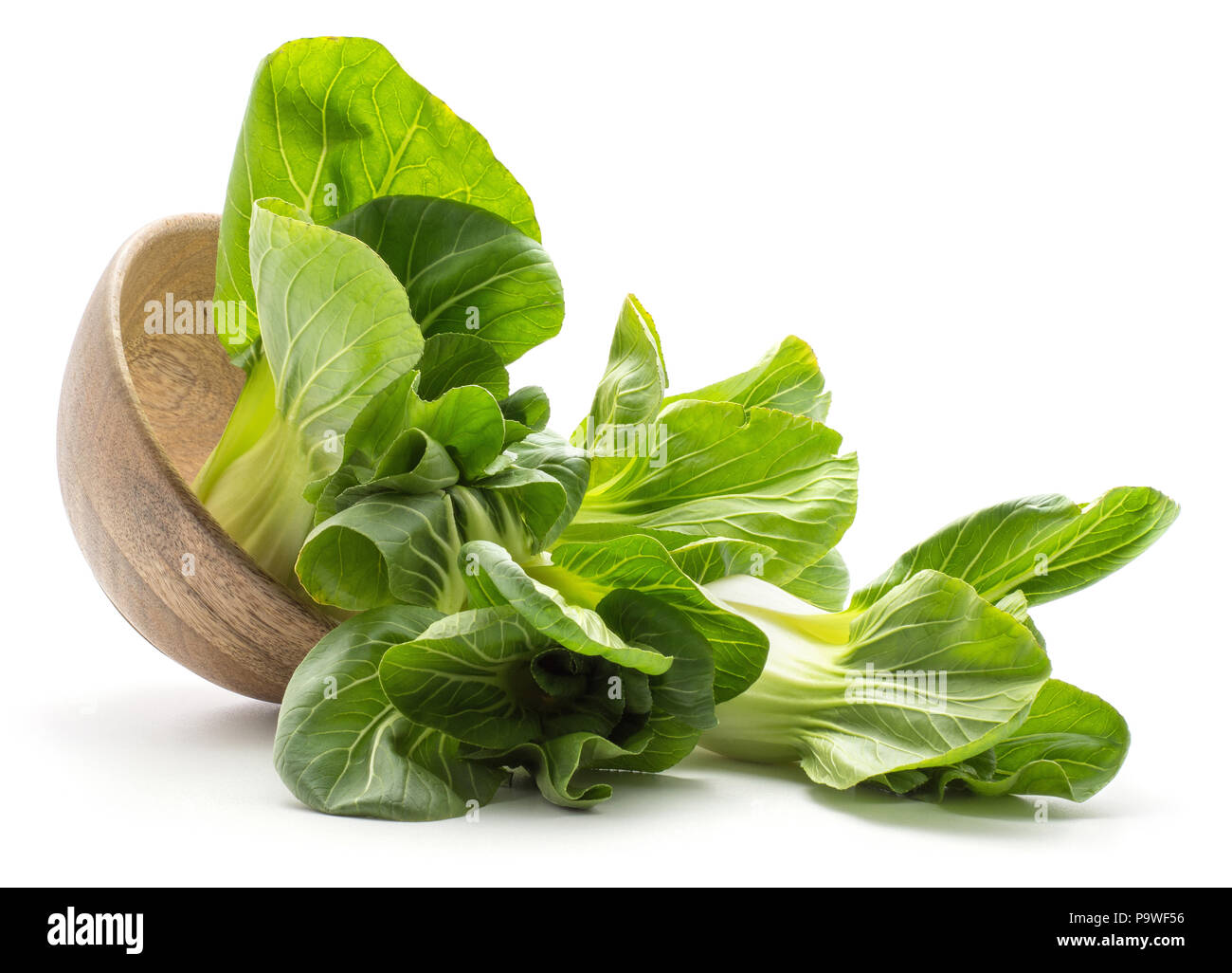 Fresh bok choy (Pak choi) out a wooden bowl isolated on white background Stock Photo