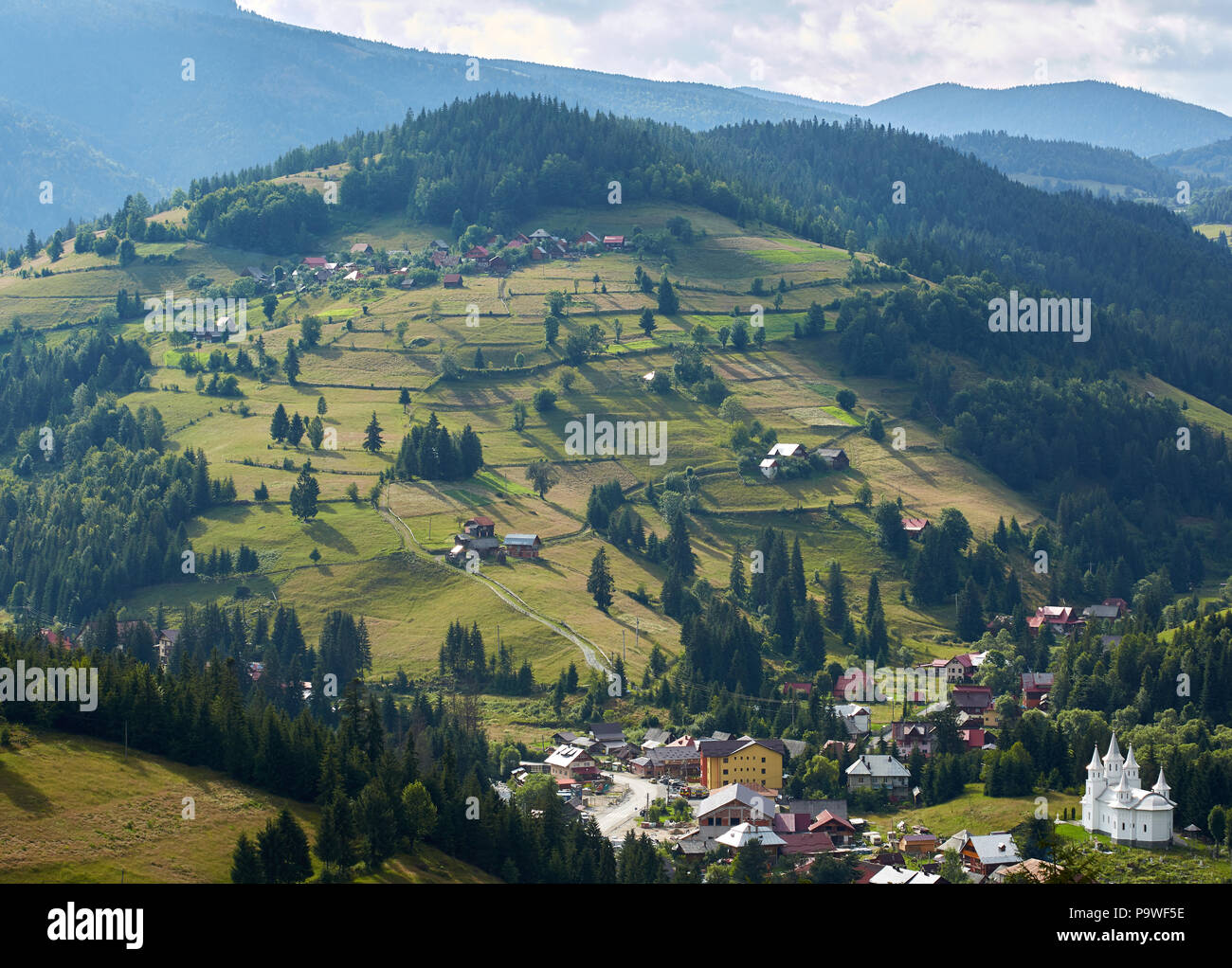 Aerial view of a village in the mountains covered in forests Stock ...
