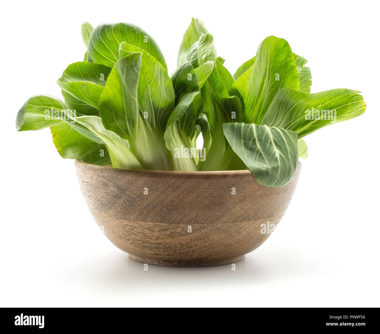 Fresh bok choy (Pak choi) in a wooden bowl isolated on white background Stock Photo