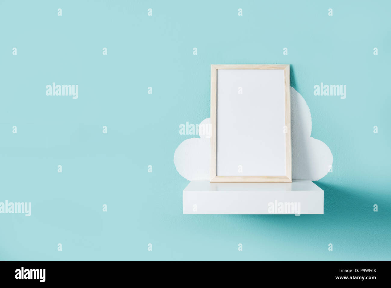 Frame mockup on turquoise wall. Copyspace. Stock Photo