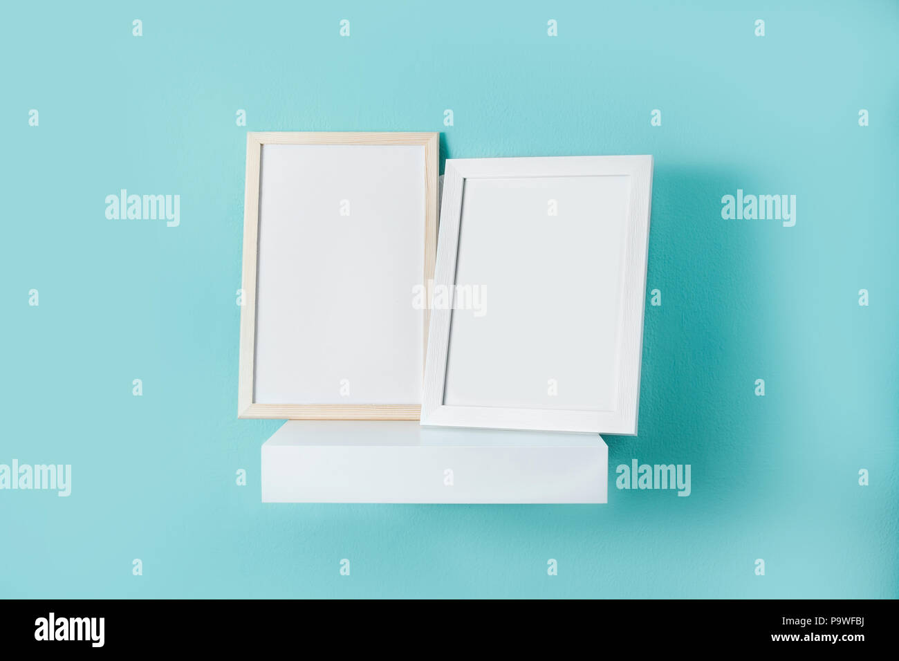 Frame mockup on turquoise wall. Copyspace. Stock Photo