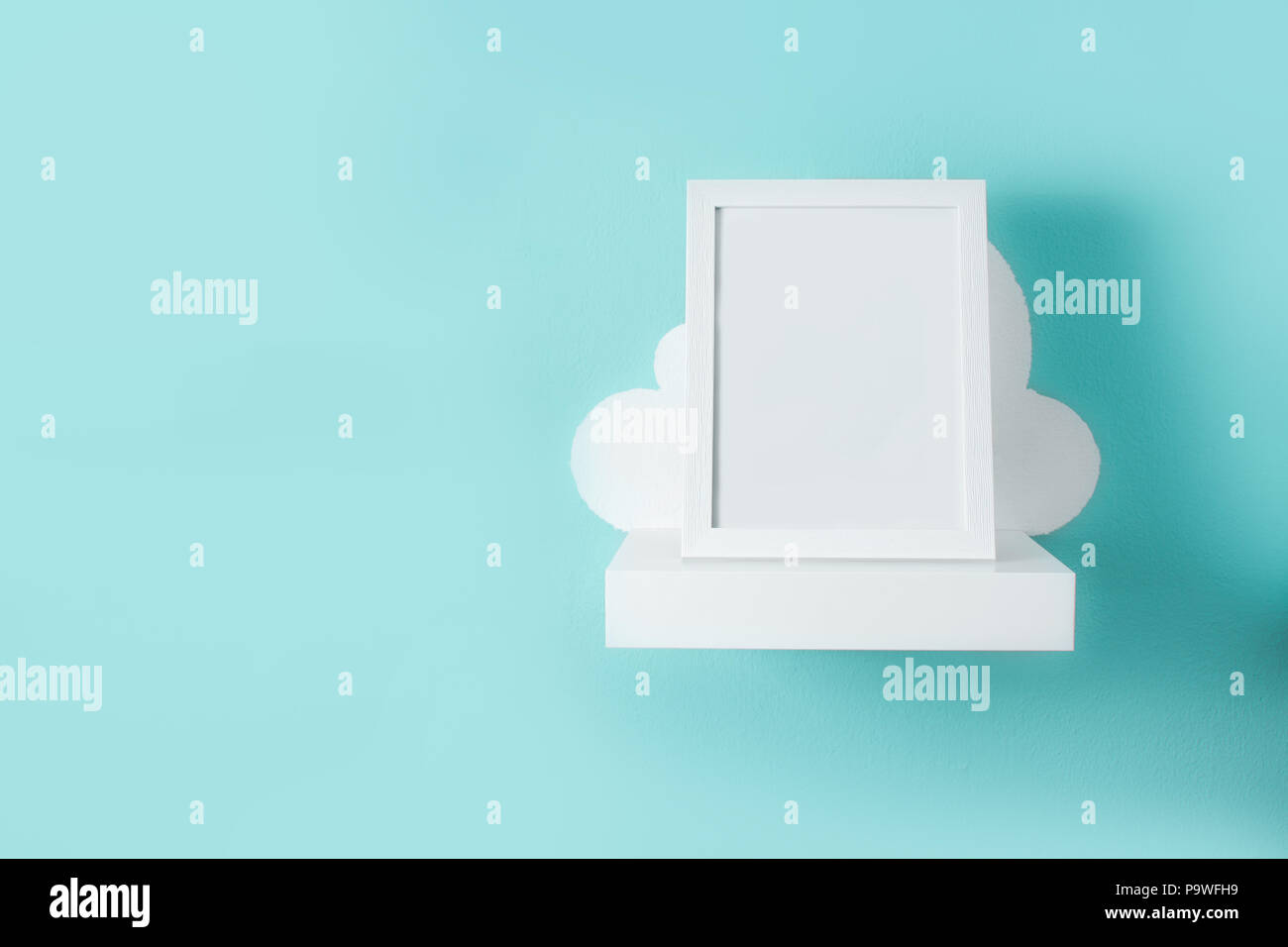 Frame mockup on turquoise wall. Copyspace. Stock Photo