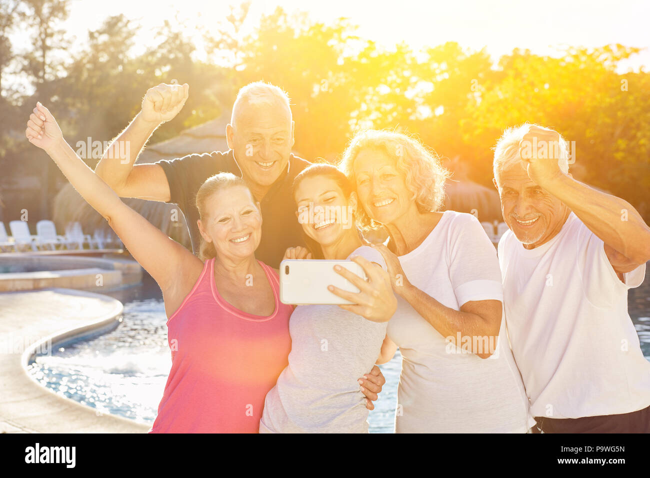 Cheering seniors group is making selfie with trainer at the wellness hotel Stock Photo