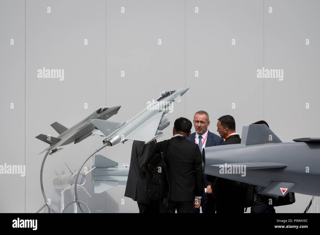 Potential customers get a briefing next to the MBDA Storm Shadow / SCALP missile system plus F-35 and Typhoon models outside the defence company's exhibition and hospitality chalet at the Farnborough Airshow, on 16th July 2018, in Farnborough, England. Stock Photo