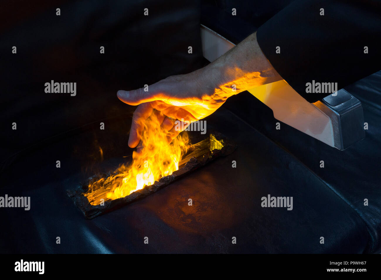 An exibition demonstration stunt by Resonate Testing Ltd. to illustrate that they test and contribute with the certification of fire-retardant airline seat materials, at the Farnborough Airshow, on 16th July 2018, in Farnborough, England. Stock Photo