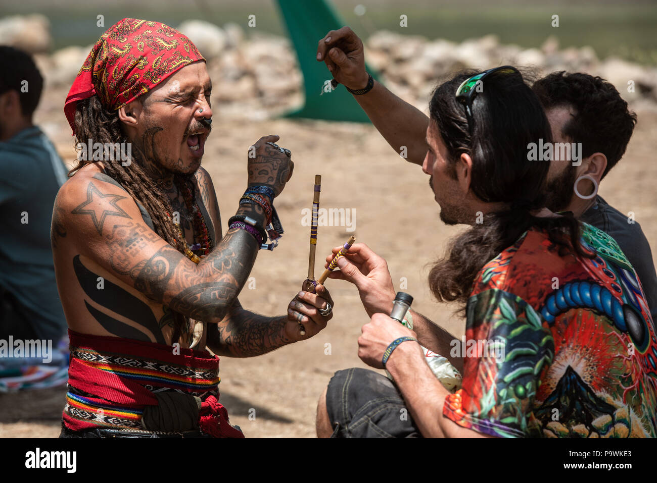 Two guys during a rapé ceremony at the Lost Theory psytrance music  festival, near Riomalo de Abajo, Extremadura, Spain Stock Photo - Alamy