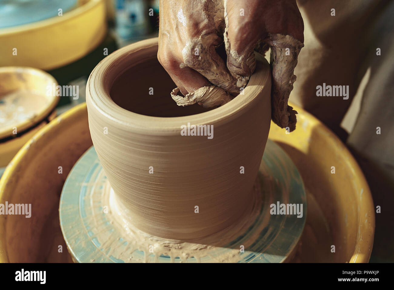 Creating a jar or vase of white clay closeup. Master crock Stock Photo
