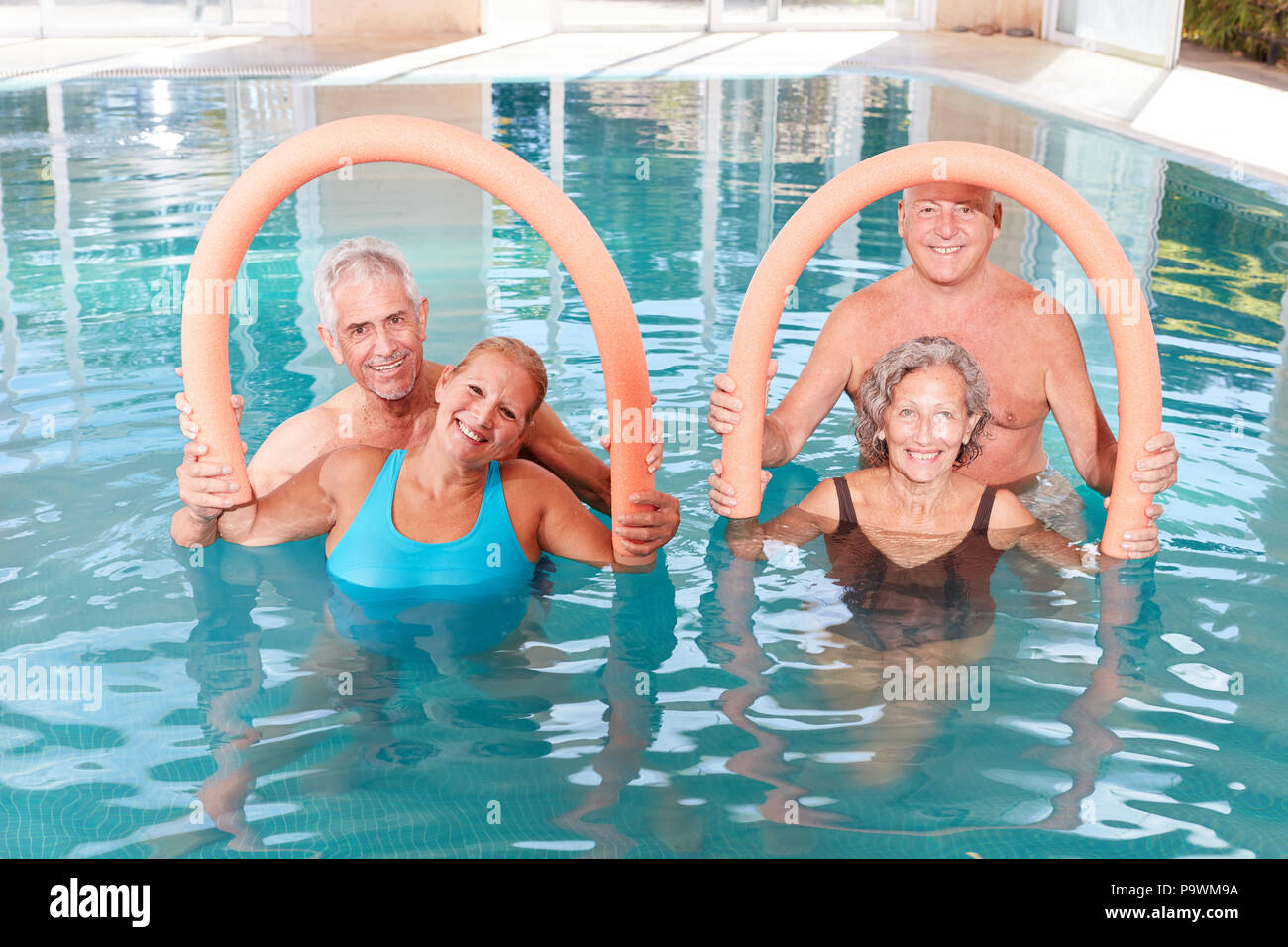 Group of seniors doing water aerobics in a rehab class in the swimming pool Stock Photo