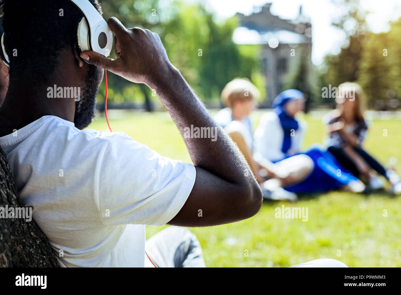 African american gentleman enjoying music in park Stock Photo