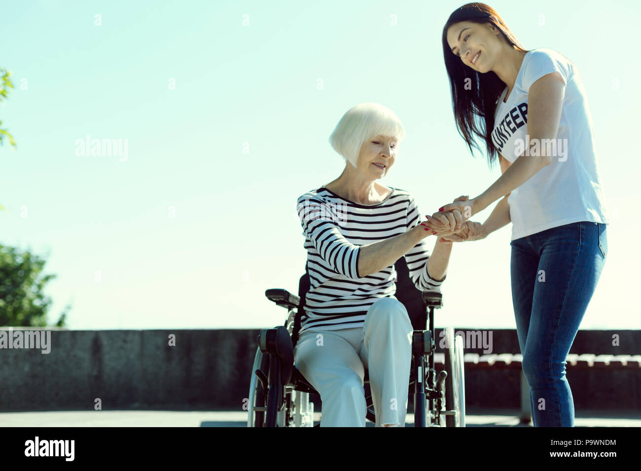 Scary blonde woman trying to stand up Stock Photo