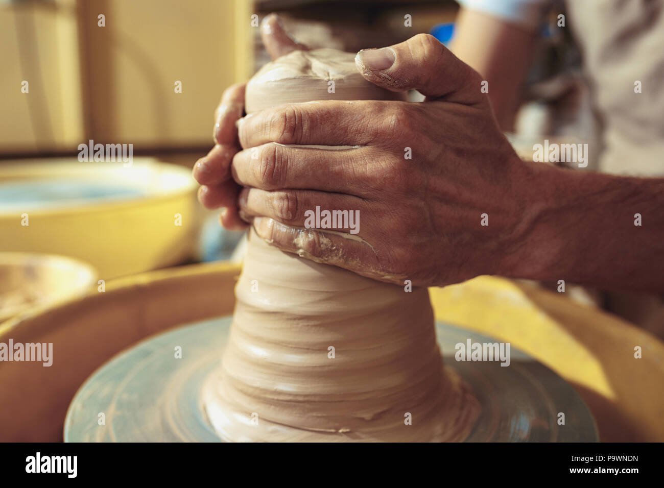 Creating a jar or vase of white clay closeup. Master crock Stock Photo