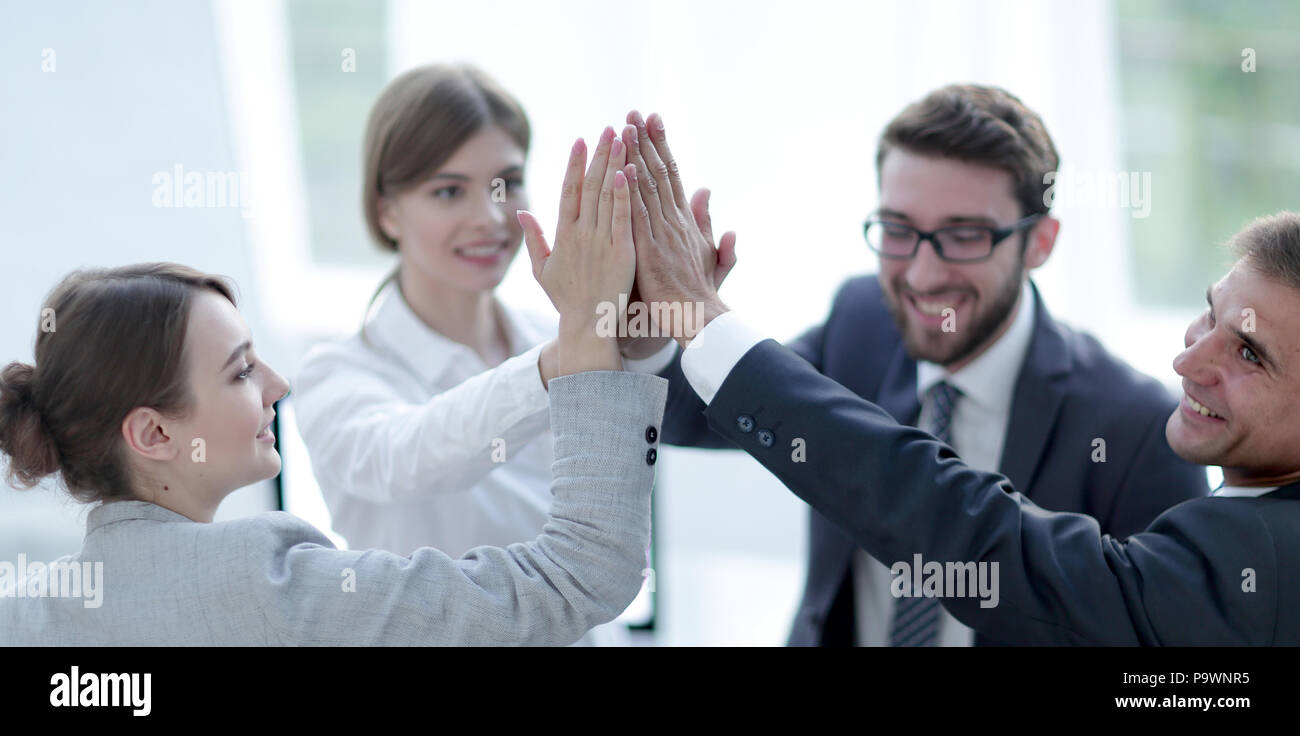 successful business team giving each other a high-five, standing in the ...