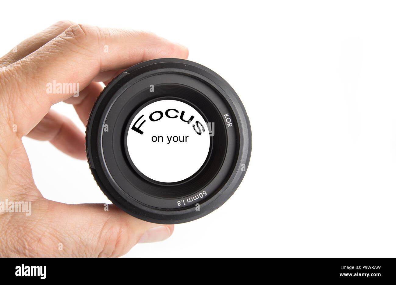 Hand holding camera lens on the white with the sign focus on Stock