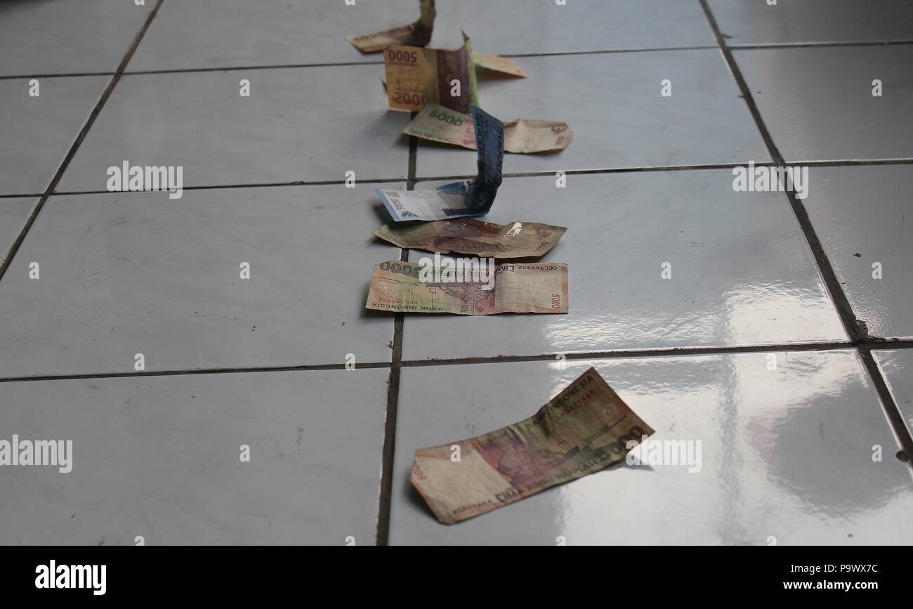 Finding money on floor Stock Photo